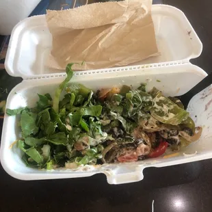a salad in a styrofoam container