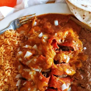 Enchilada plate with 75¢ charged for raw onions