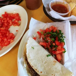 Barbacoca taco, onion, cilantro and $1.00 tomatoes