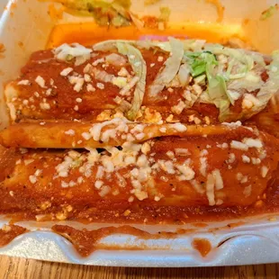 Huge tamales - pork tamale in front and chicken tamale topped with lettuce in back