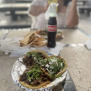 a woman sitting at a table with a plate of food