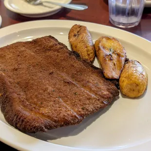 Breaded and fried pork loin with plantains (rice and beans on another plate)