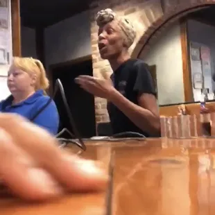 a woman sitting at a bar