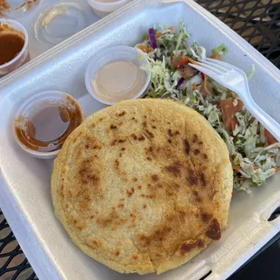 Pork Pupusa, with curtido, salsa and a cream salsa