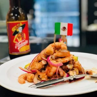 a plate of food and a bottle of beer