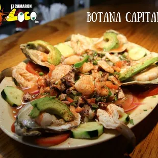 Botana Capitan - a delicious seafood bed. With shrimp, oysters, octopus &amp; more.