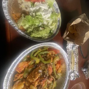 Fajitas Texanas and rice and beans with guacamole, sour cream, and fresh lettuce and tomatoes.  Delicious....