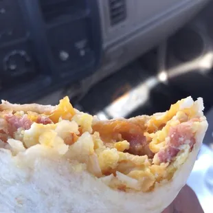 a person holding a burrito in their hand