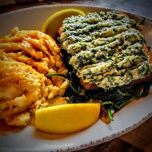 Grilled Wild Salmon - Fresh salmon filet pan seared and topped with our house made herb crust. Served on top of fresh sautéed spinach.