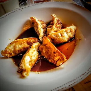 Pot Stickers - Six pan-fried dumplings stuffed with pork filling. Served with housemade ponzu sauce.