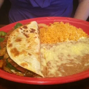 Vegetarian #4 I believe. Peppers, onions, and mushrooms sauteed in a  tortilla with Re-fried beans and Spanish rice.