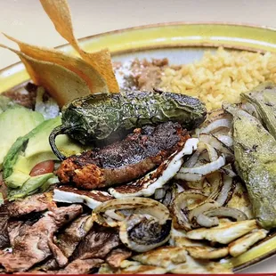 Rice ,beans, asada , chicken,chorizo,queso fresco, salad, nopal and fried jalapeño