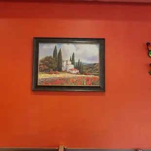 a dining room with orange walls