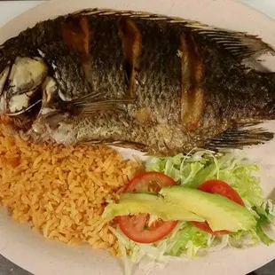 a plate of fish and rice