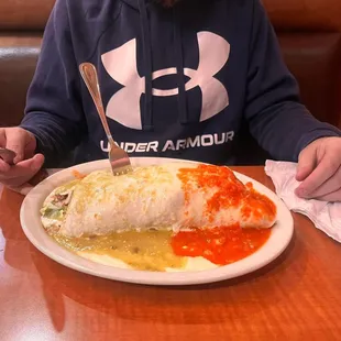 a man sitting at a table with a plate of food