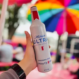 a person holding a bottle of ultra