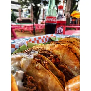 a plate of tacos and a coke