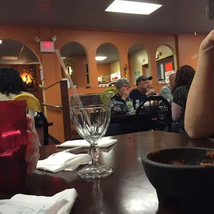 a woman sitting at a table in a restaurant