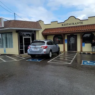 a car parked in front of a restaurant