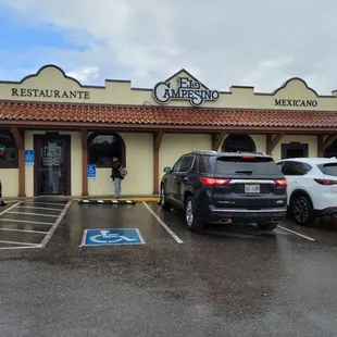 cars parked in front of a restaurant