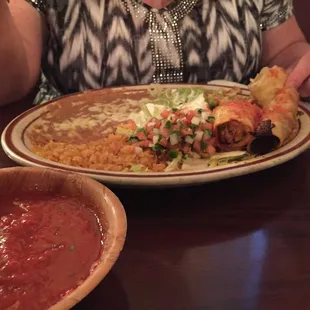 a plate of mexican food and a bowl of salsa