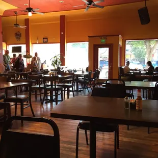 people sitting at tables in a restaurant
