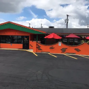 a restaurant with red umbrellas