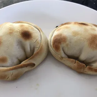 two empanadas on a white plate