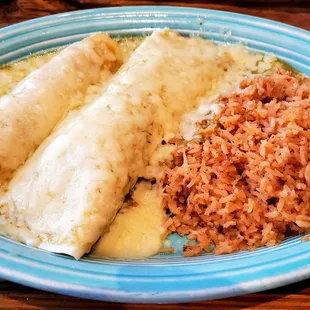 Gonzalez Special: Beef Burrito, Chicken Enchilada, Mexican Rice, topped with Queso and Salsa Verde. Muy Delicioso!