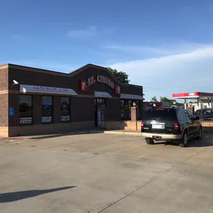 two cars parked in front of a restaurant
