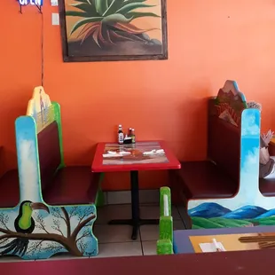 Painted Dining Room Booth. - all booths are painted in traditional fresco colors - each with their own murals on the seat backs.