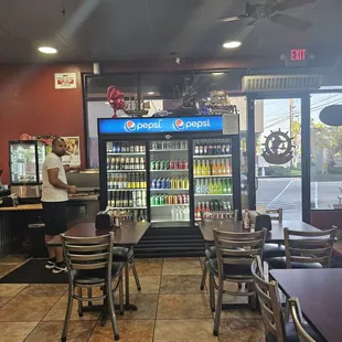 Inside seating and dessert display case to the left and salsa station and other drink choices.