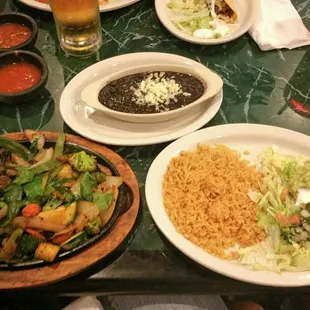Vegetarian fajitas cooked in no oil with black beans and corn tortillas. Cooked to perfection!