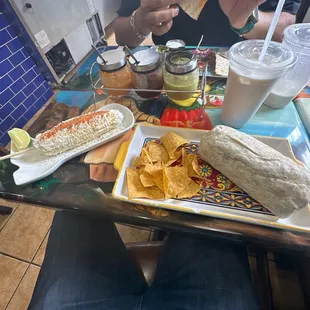 10. Bean Burrito, orchata , Street Corn Elote and an assortment of spicy sauces.