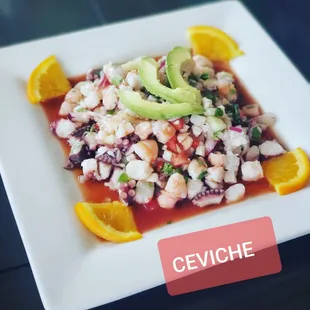 a plate of food with oranges and avocado