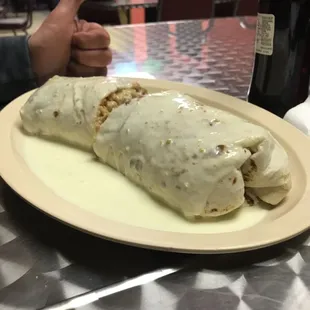 Burrito supreme with fajita steak &amp; veggies in the inside and top with creamy cheese sauce