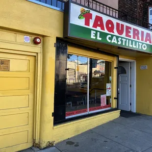a yellow building with a sign that says taqueria el castillio