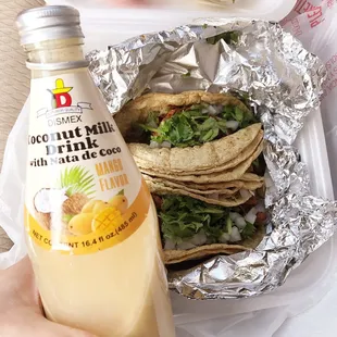 3 tacos al pastor with a coconut milk drink