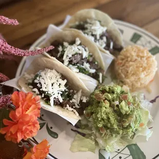 a plate of tacos and rice