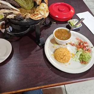 Molcajete, it comes with faita beef, chicken,shrimp, rice, beans, tortillas, and guacamole