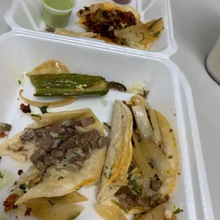 a plate of tacos and sauces