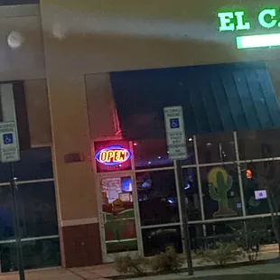 a neon sign in front of a restaurant