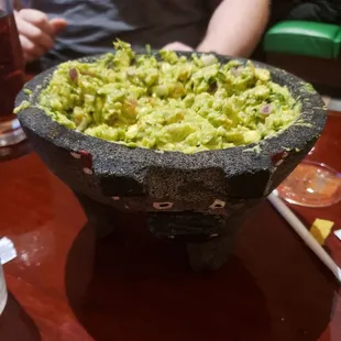 a bowl of guacamole on a table