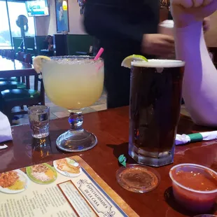 a person sitting at a table with drinks