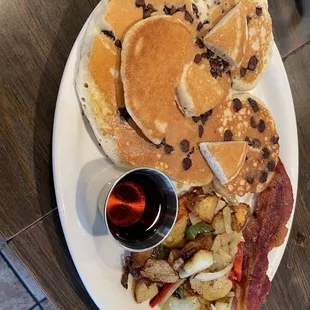 Chocolate chip pancake with country potatoes and bacon