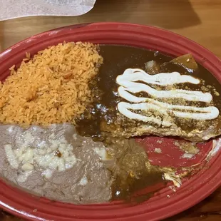 Combination 3 cheese enchiladas with molè, rice and refried beans.