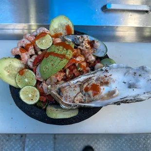 a plate of oysters and vegetables