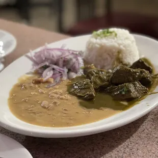 Seco de cordero con arroz y frijoles, the onions are lightly pickled, so toothsome