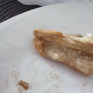 Hair in between some type of potatoe that was added on to make the jalea plate looking full