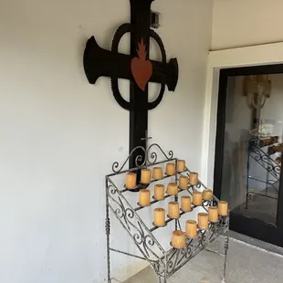 a cross with candles on it